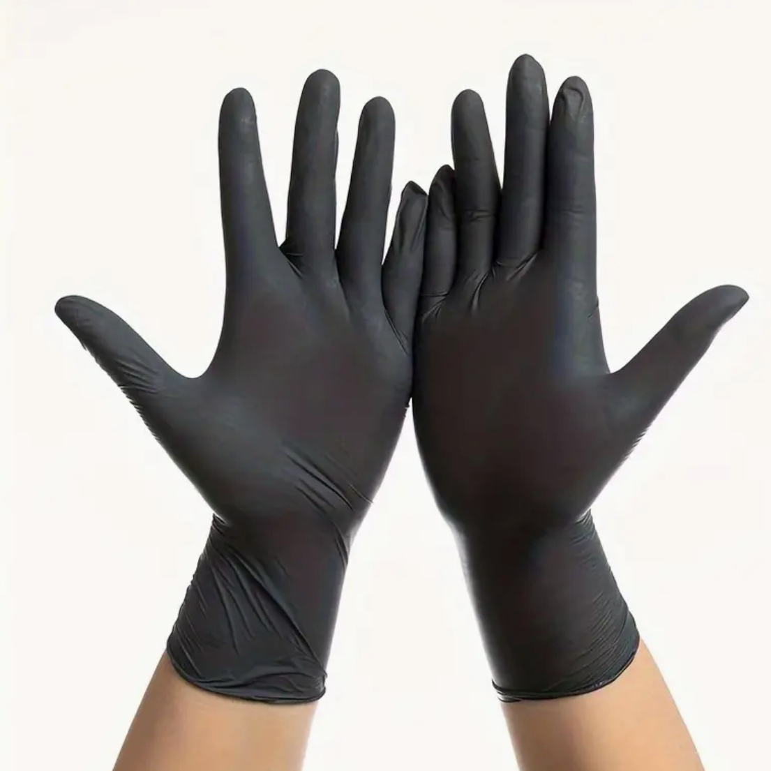 Hands wearing black nitrile gloves raised against a white background.