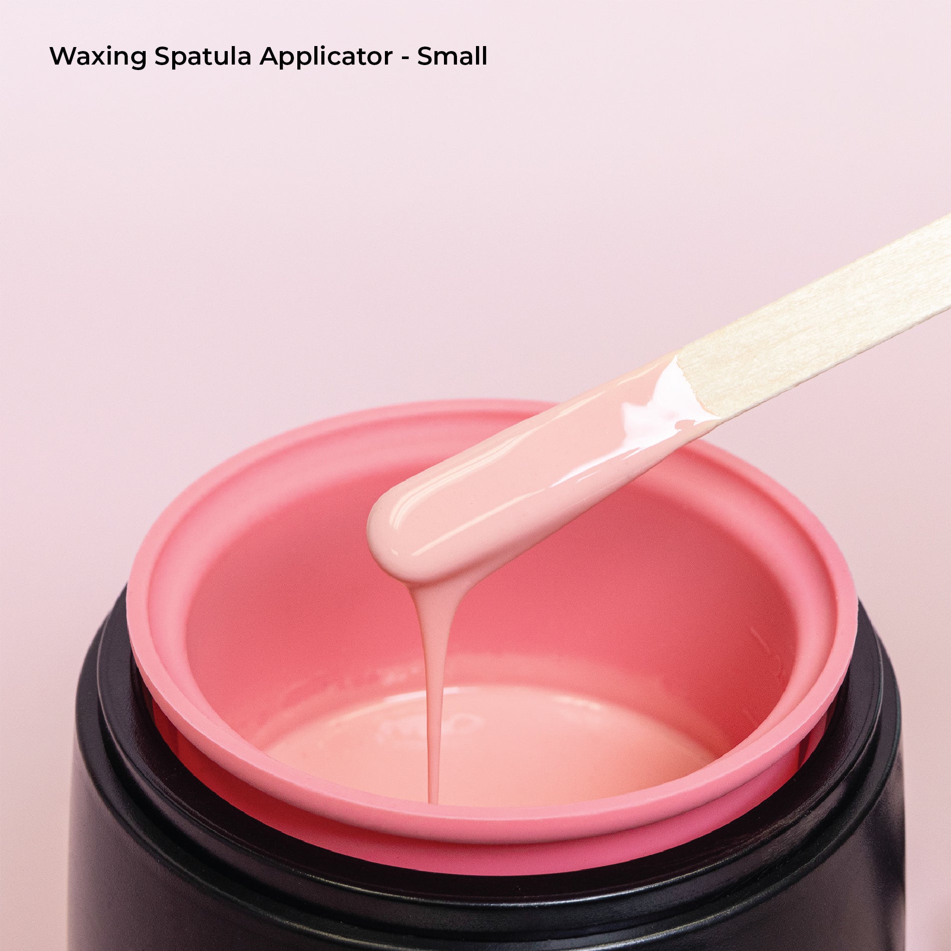 Using small spatula to pick up wax.