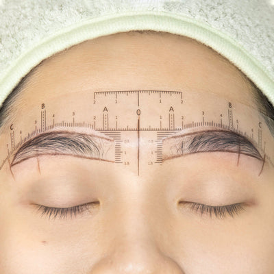 The Eyebrow Ruler Sticker on a model's head.