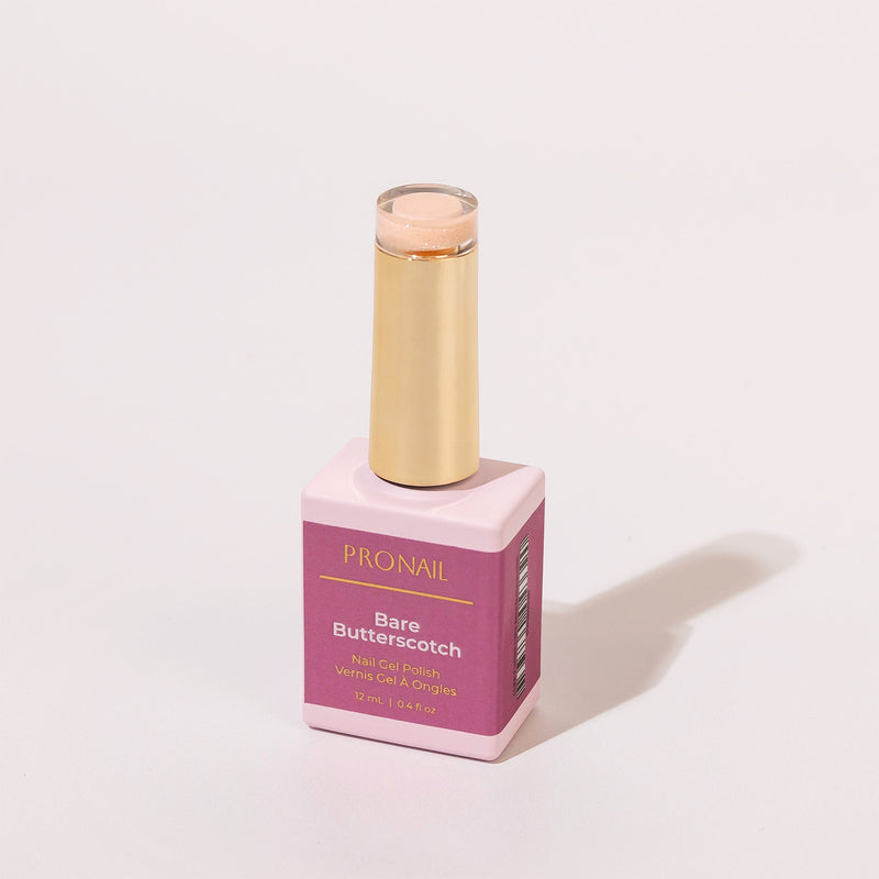 A Bare Butterscotch nail polish bottle with a gold cap casting a shadow on a white background.