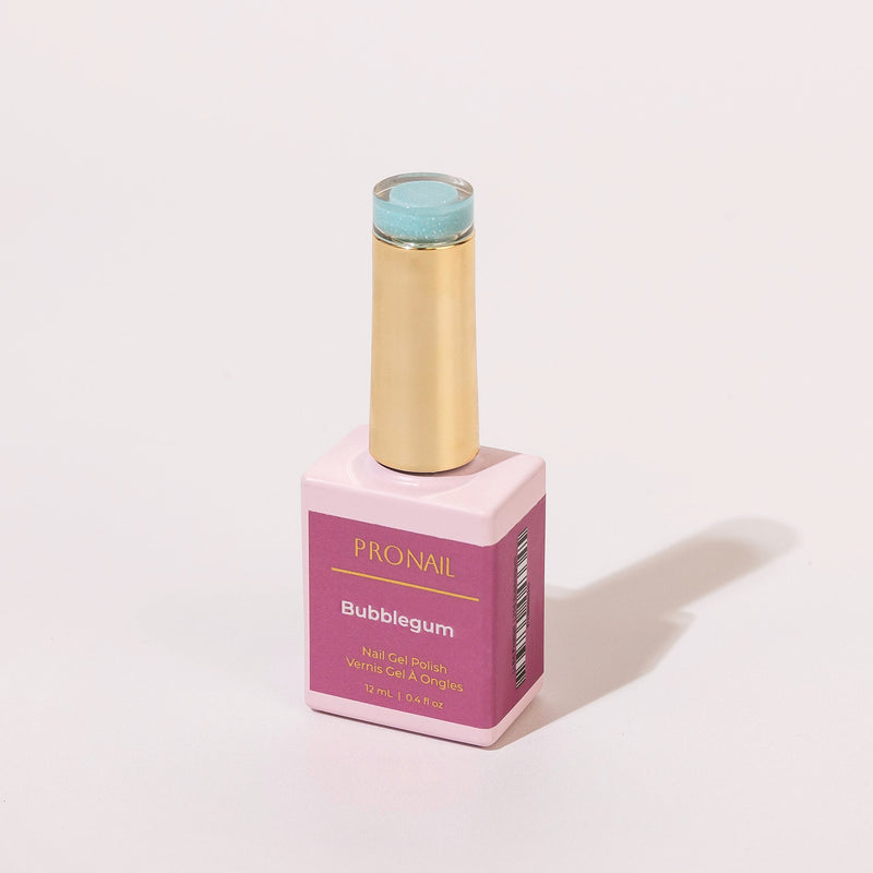 A Bubblegum nail polish bottle with a gold cap casting a shadow on a white background.