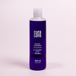 Azulene & Menthol Extra Dry Oil Bottle Over Light Background