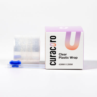 Curacoro clear plastic wrap roll, packaging, and cutter, 42mm x 200m, on a white background.