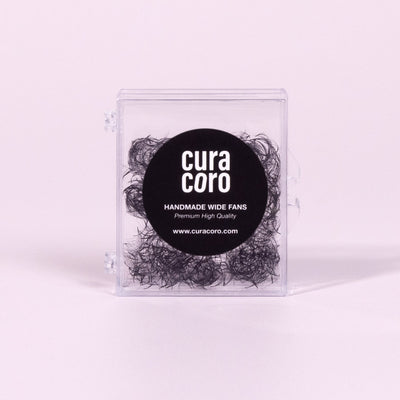 Curacoro Handmade Wide Fans in a transparent box with black branding, displayed against a light pink background.