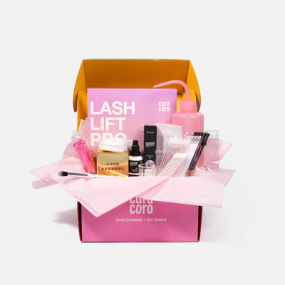 Curacoro Lash Lift Pro kit with lash lifting and tinting tools in an open pink and yellow box on a white background.