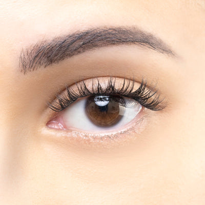 Close-up of an eye with natural-looking eyelash extensions, featuring subtle length and volume for an everyday look.