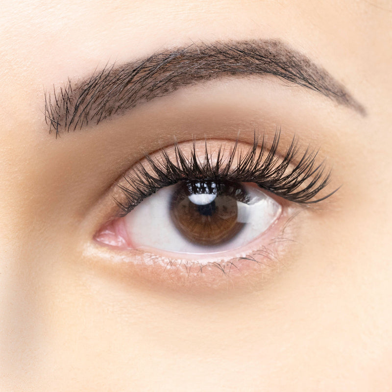 Close-up of an eye with dark, voluminous eyelash extensions, showcasing long and full lashes with a natural curl.