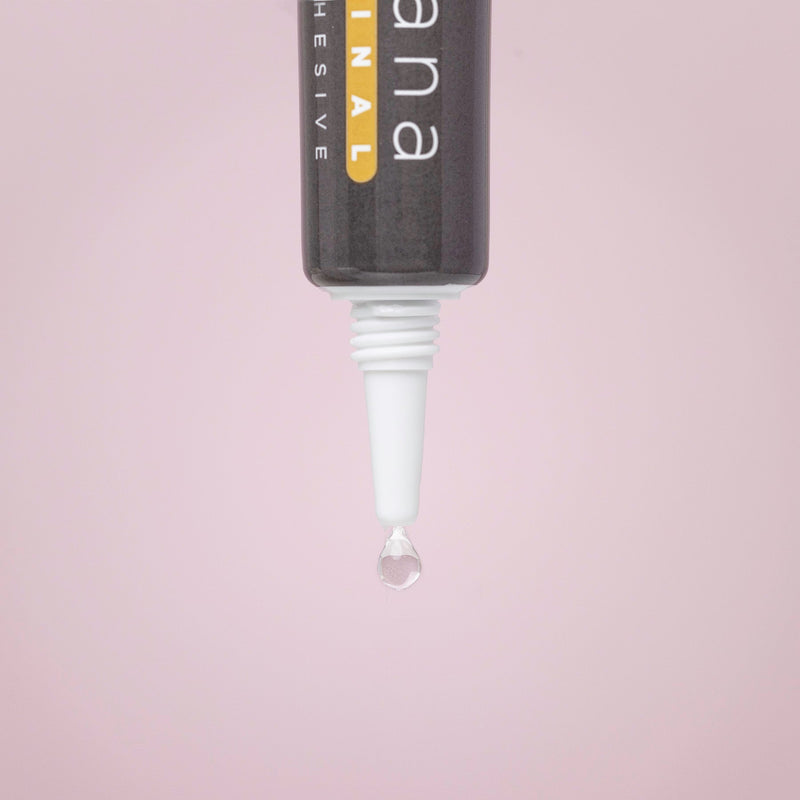 Lash lift adhesive with a drop of glue on a pink background