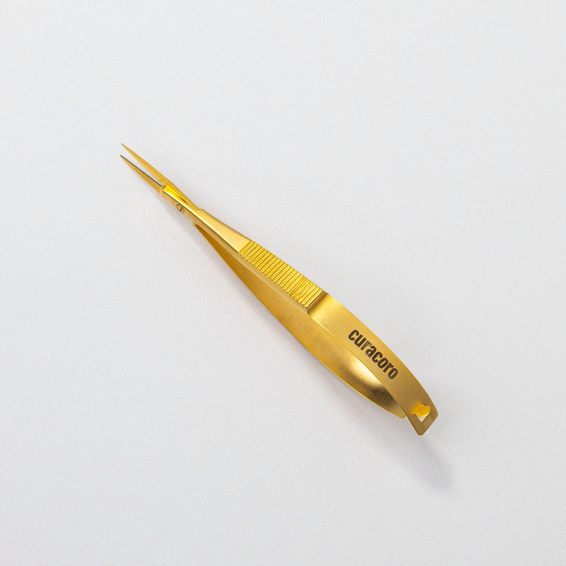 Gold Eyebrow Scissors in front of a white background.