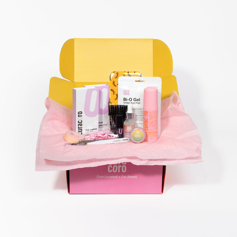 Curacoro Eyelash Extension Training Kit displayed inside a pink and yellow box with a tissue paper lining, against a white background.