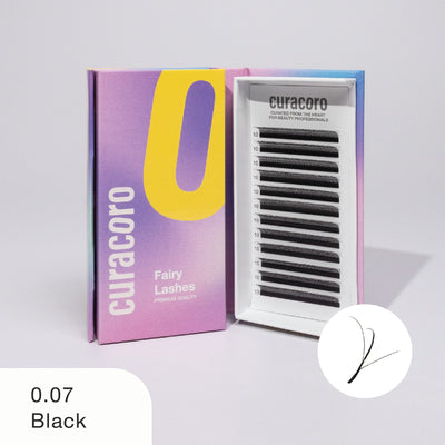 Curacoro Fairy Lashes in black, style 0.07, displayed with its open box showing arranged lash trays on a white background.