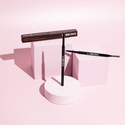 I ❤️ Brows Brow Pencil in front of a pink background.