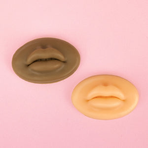White and dark styles of 3D Silicone Lips standing in front of a pink background.