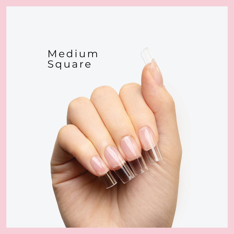 medium nail tips displayed on fingers with a clean, pink-bordered background.