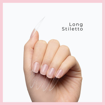 Curacoro Long Sitletto Soft Gel Nail Tips on a hand, featuring natural nails with clear extensions, set against a white background with a pink border.