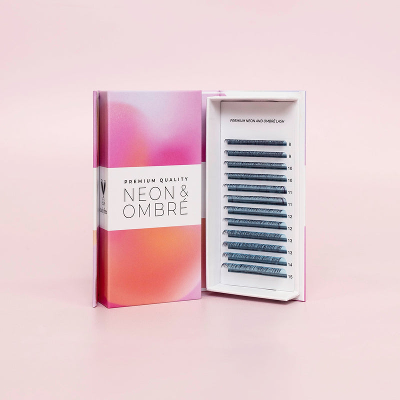 Curacoro Neon & Ombré lash tray displayed in an open box with premium gradient packaging in pink and orange tones, showcasing lash extensions of varying lengths.