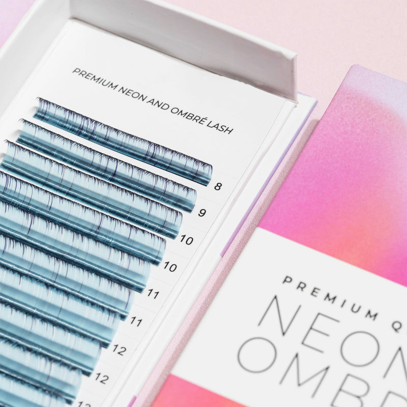 Close-up of Curacoro Neon & Ombré lash tray showcasing ombré lash extensions in various lengths, displayed in premium packaging with a gradient pink and orange design.