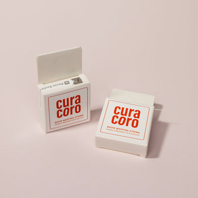 Two Curacoro Brow Mapping String Boxes Over a light pink Background