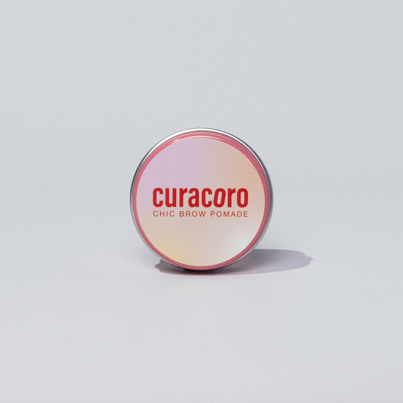 Curacoro Chic Brow Pomade in front of a white background.