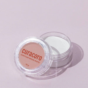 Image of our Contour Brow Paste standing in front of a pink background.
