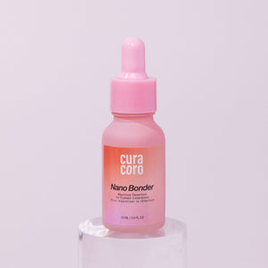 Curacoro Nano Bonder, 15 ml bottle, for maximizing eyelash extension retention, on a pink background.