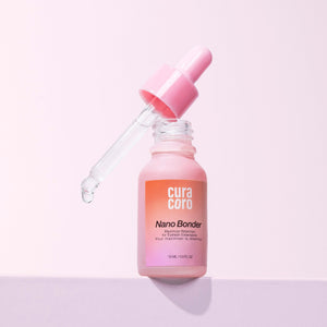 Curacoro Nano Bonder bottle with dropper dispensing liquid, 15 ml, on a pink background.