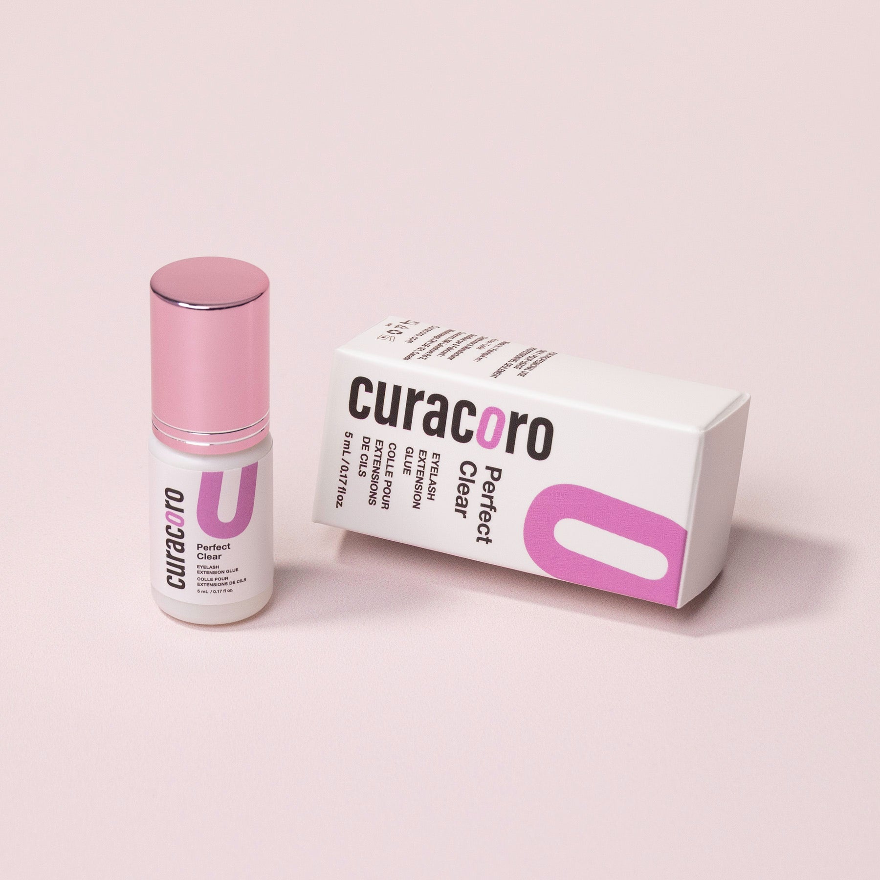 Curacoro Perfect Clear Eyelash Glue with box on neutral background.