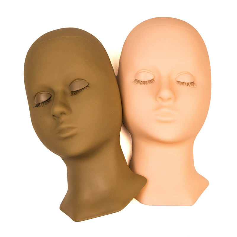 Two lash training mannequin heads in dark and light, positioned side by side with closed eyes, ideal for eyelash extension practice.